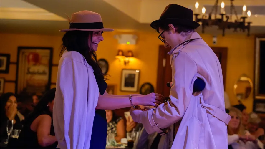 A Murder Mystery Company detective questioning a guest at a Houston show