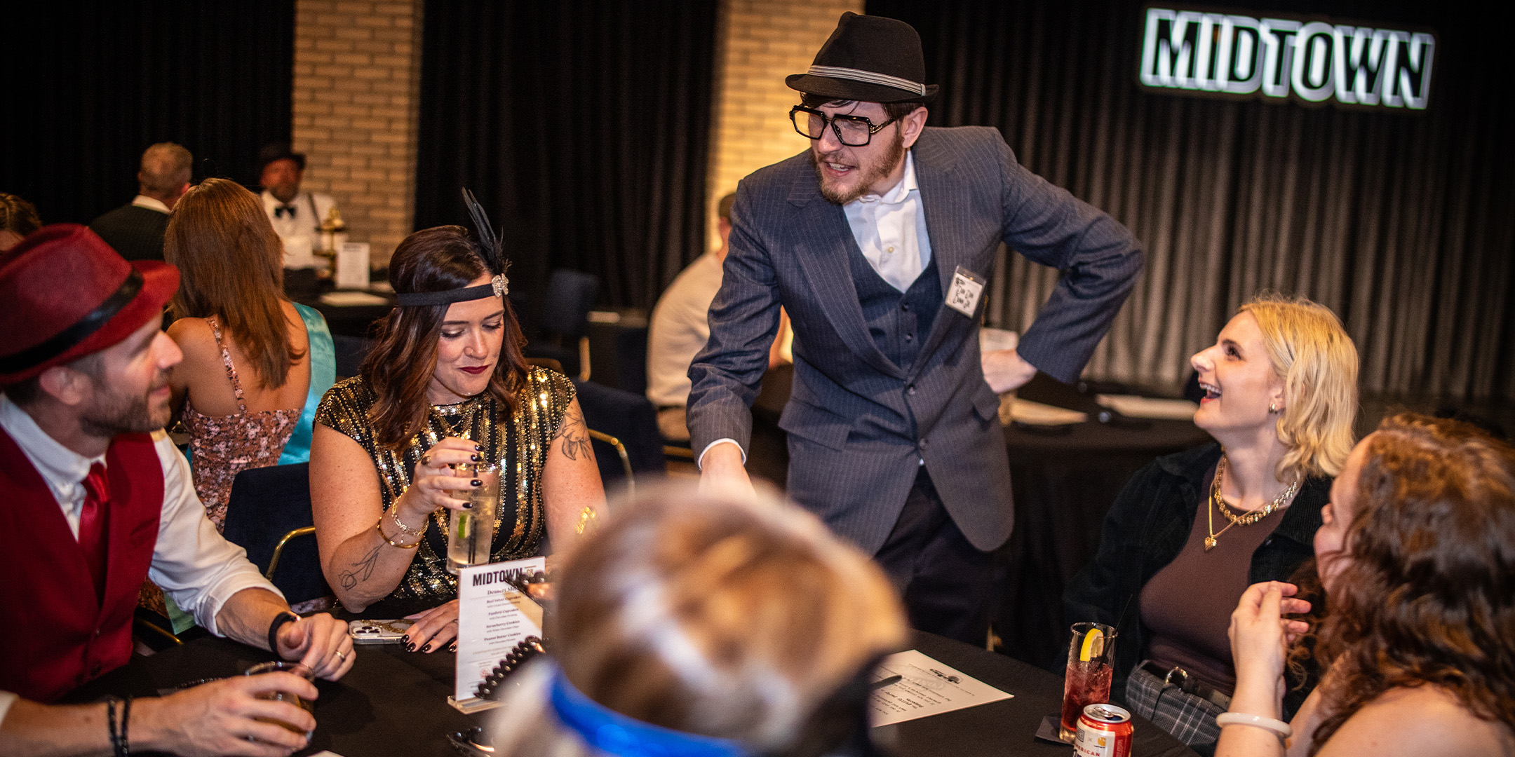 Guests at a Murder Mystery Company public dinner show in Houston